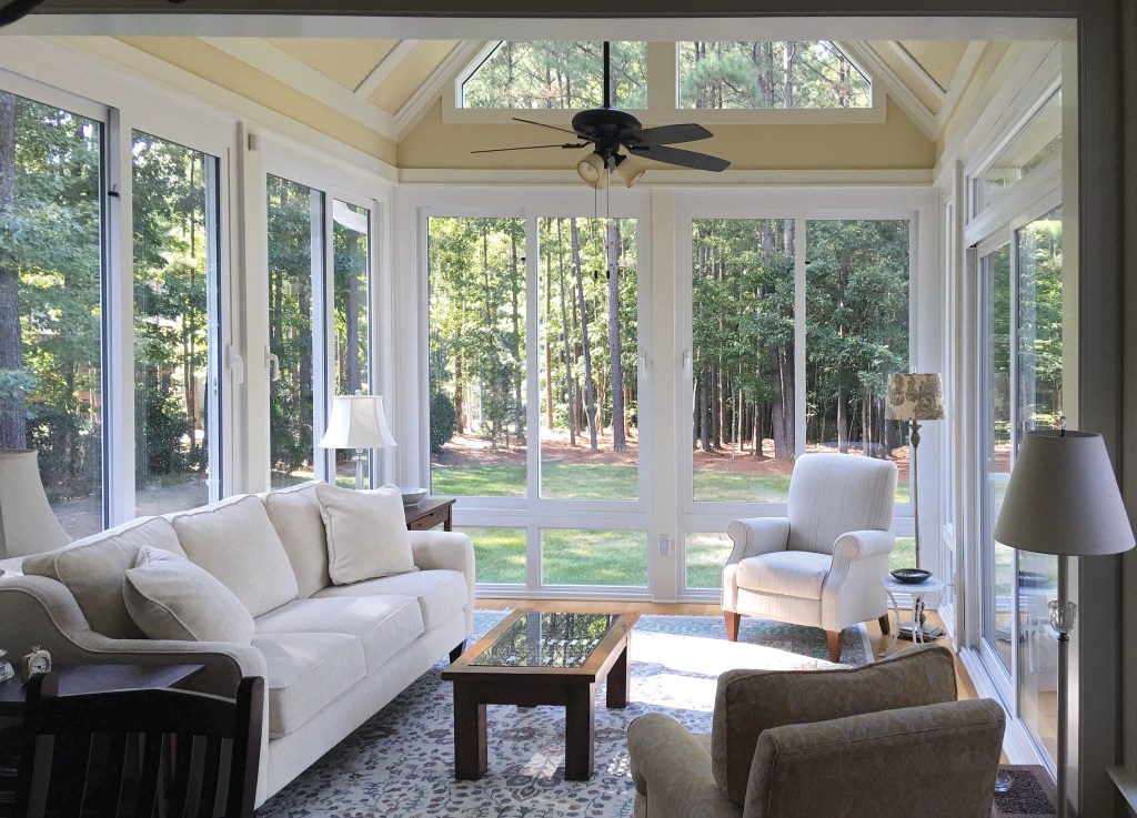 Spacious four-season sunroom design with large windows and cozy seating in a Cleveland, Ohio home